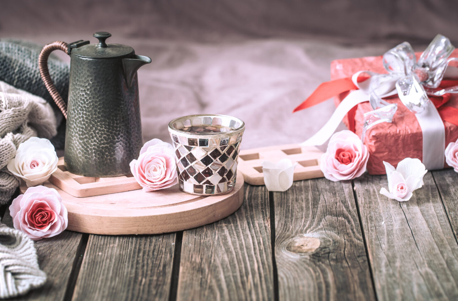 Concept for Valentine's Day or Mother's Day, a festive still life with tea and a teapot on a wooden table in the living room at home